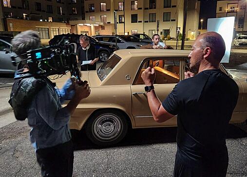 Paul O'Conner and Andrew Turman discuss shooting a scene with Thomas Middleditch and Larry Guterman in the background.